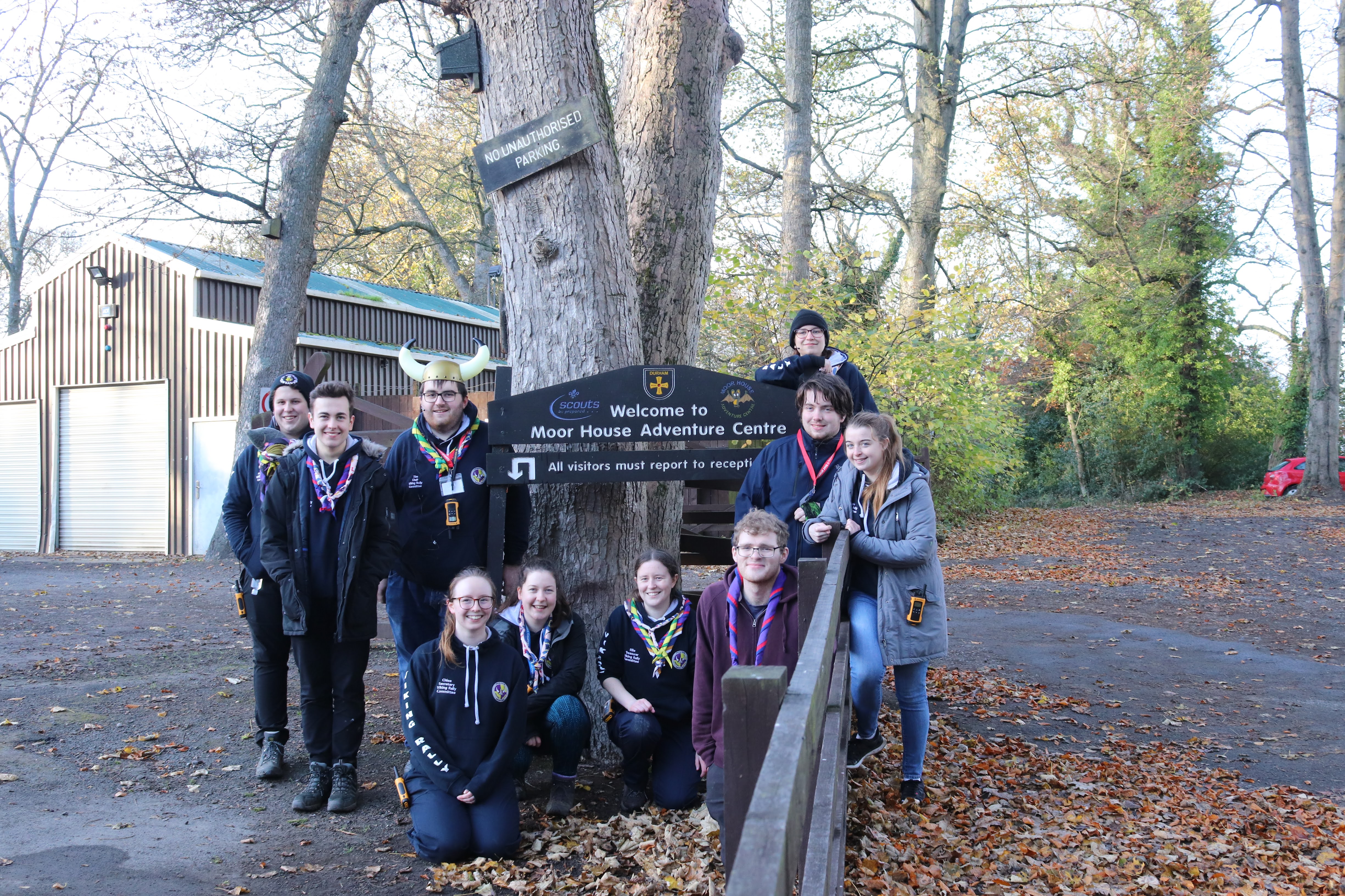 The Viking Rally committee, all together in one place for the first time ever, in front of the campsite sign in the carpark